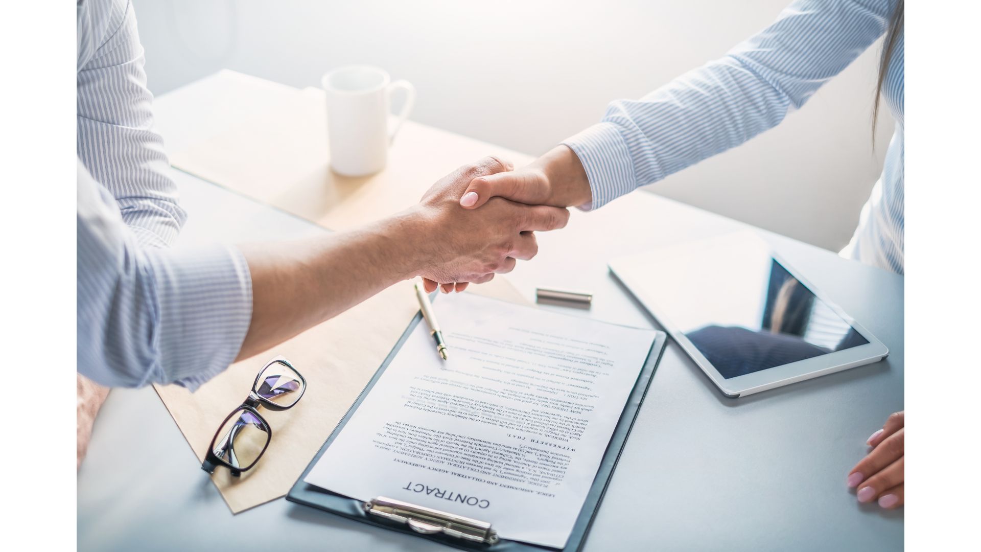 Acuerdo comercial cerrado con un apretón de manos sobre un contrato